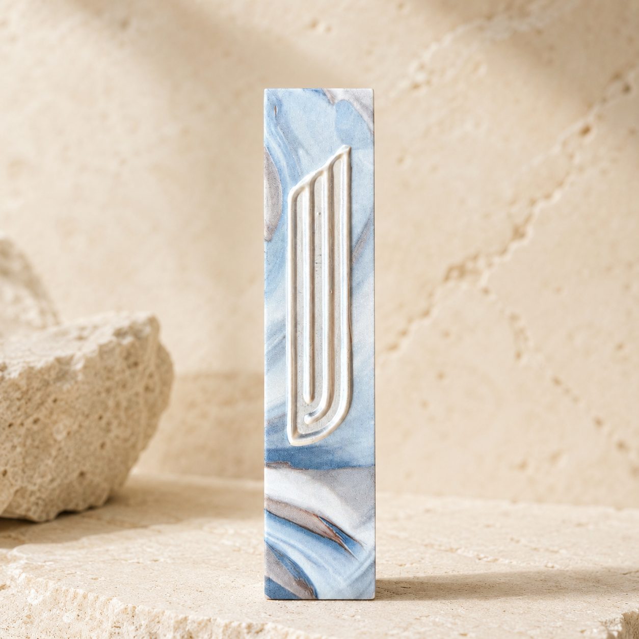 Marbled mezuzah on travertine